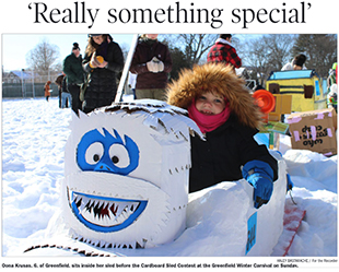 Girl on Cardboard Yeti Sled at Winter Carnival 2026